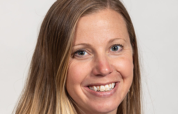 A woman with long blonde hair smiles for the camera.