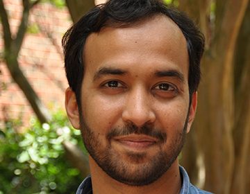 A man with a beard and blue shirt