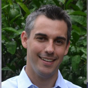 A man with grey hair and a blue shirt