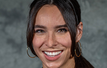 A woman with long hair and a smile.