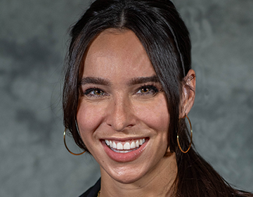 A woman with long hair and a smile.