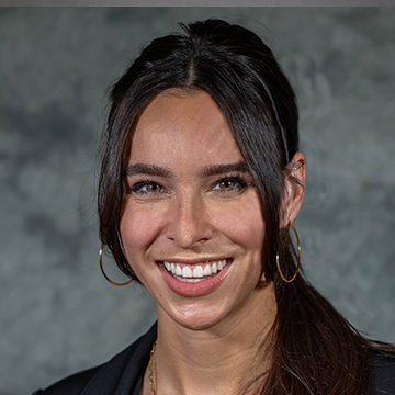 A woman with long hair and a smile.