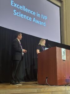 Henry Xiang receives award from Ashley Brooks-Russell