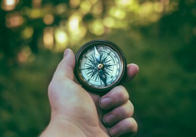 Image of a hand holding a compass