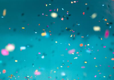 image of colorful confetti on a teal background
